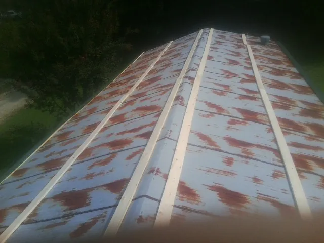 Rusted metal roof panels with new wood purlins before replacement — Storm Damage Roof Repair in Fowler by Roofing Brothers